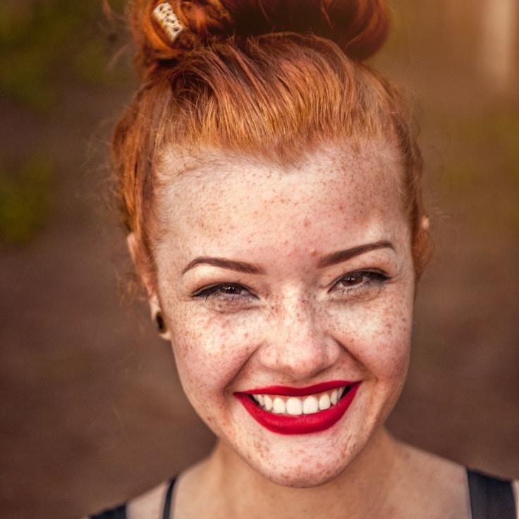 Avery Lin, Lead Design Curator at Field Linen Market, reviewing corporate floral arrangements